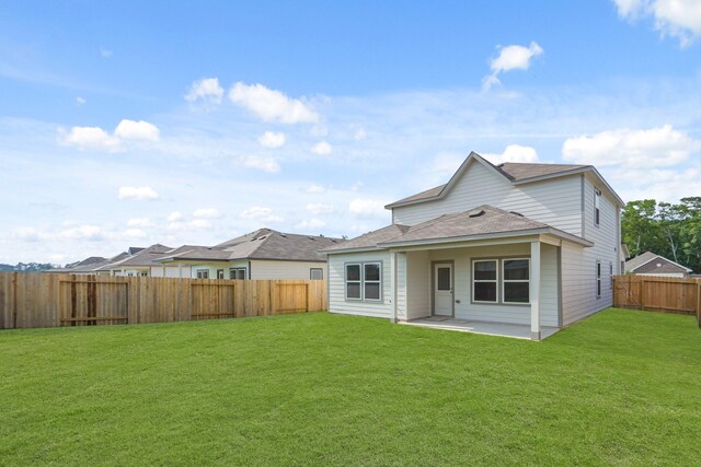 17824 Lionheart Rd, Conroe, TX 77306 - back of house featuring a lawn, a patio, a shingled roof, and a fenced backyard