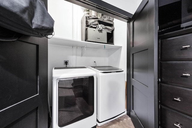 clothes washing area with washer and clothes dryer and laundry area