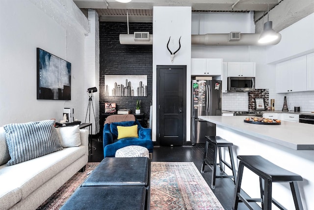 living area with dark wood-type flooring and visible vents