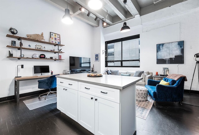 kitchen featuring white cabinets, open floor plan, light countertops, dark wood finished floors, and beam ceiling