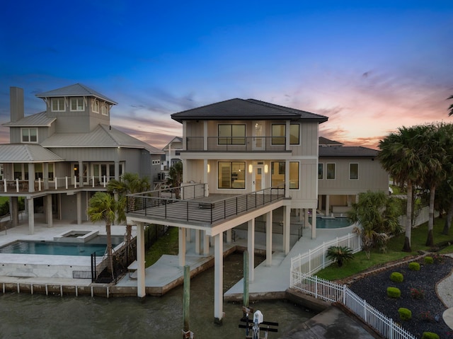 1303 Oahu Dr, Tiki Island, TX 77554 - rear view of property featuring a balcony, a fenced backyard, stairway, and a patio