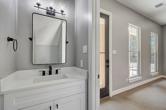 1420 Weiss St, Houston, TX 77009 - bathroom with wood finished floors, plenty of natural light, baseboards, and vanity