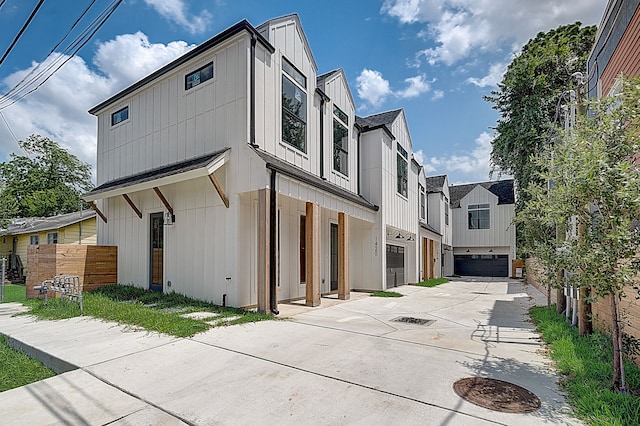 1420 Weiss St, Houston, TX 77009 - modern farmhouse featuring an attached garage, board and batten siding, driveway, and a residential view