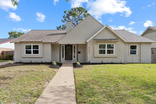 5606 Arbor Vitae Dr, Houston, TX 77092 - view of front facade featuring brick siding, a chimney, and a shingled roof