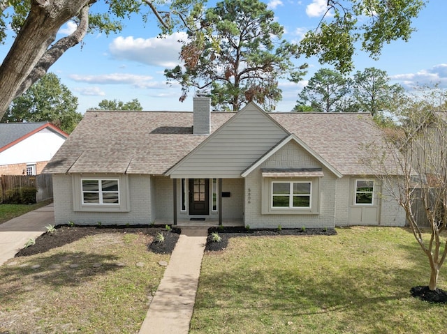 5606 Arbor Vitae Dr, Houston, TX 77092 - view of front facade with brick siding, a chimney, roof with shingles, and a porch