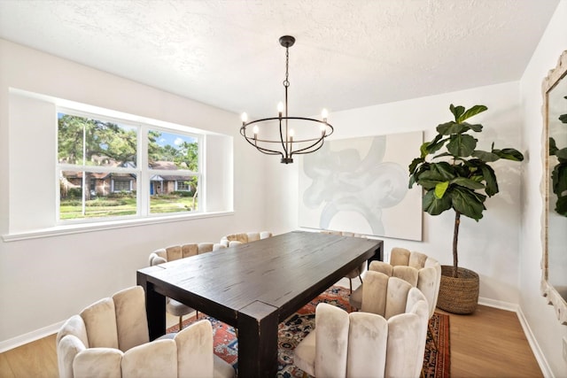 5606 Arbor Vitae Dr, Houston, TX 77092 - dining space with a chandelier, wood finished floors, and a textured ceiling