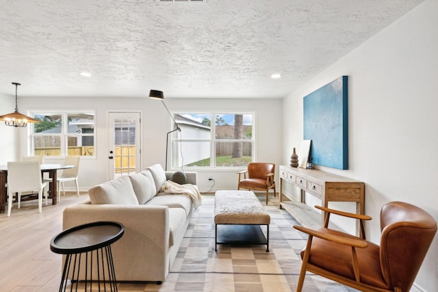 5606 Arbor Vitae Dr, Houston, TX 77092 - living room with a textured ceiling, recessed lighting, and light wood-style flooring