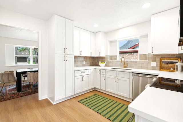 5606 Arbor Vitae Dr, Houston, TX 77092 - kitchen with dishwasher, light wood-type flooring, light countertops, decorative backsplash, and recessed lighting