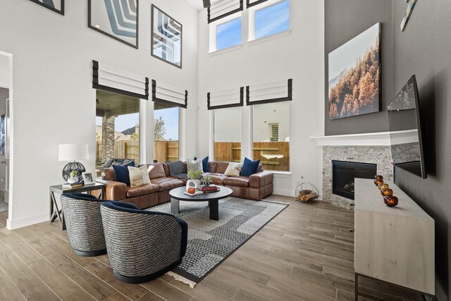 500 Dove Meadow Ln, Katy, TX 77493 - living room featuring wood finished floors, a high ceiling, baseboards, and a fireplace