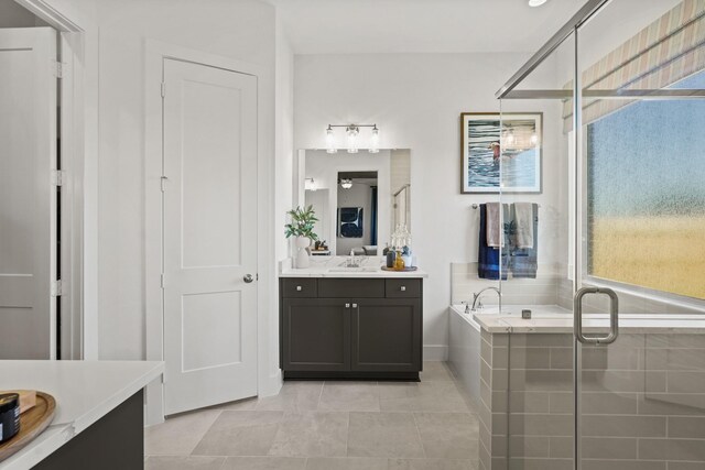 500 Dove Meadow Ln, Katy, TX 77493 - bathroom featuring two vanities, a shower stall, tile patterned floors, a bath, and baseboards