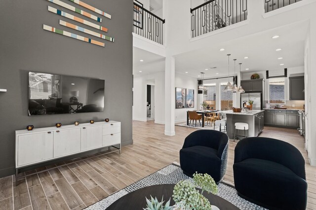 500 Dove Meadow Ln, Katy, TX 77493 - living room with light wood finished floors, baseboards, a high ceiling, and recessed lighting