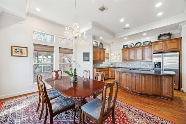 5768 Sugar Hill Dr, Houston, TX 77057 - dining room featuring an inviting chandelier, recessed lighting, crown molding, visible vents, and light wood finished floors