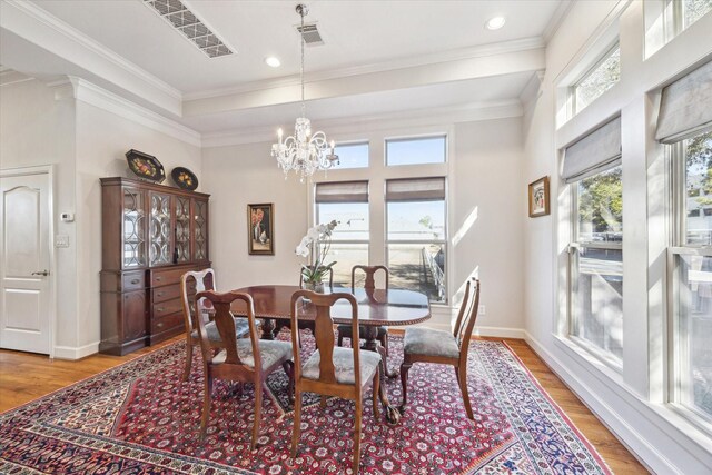 5768 Sugar Hill Dr, Houston, TX 77057 - dining space featuring light wood-style floors, an inviting chandelier, ornamental molding, visible vents, and baseboards