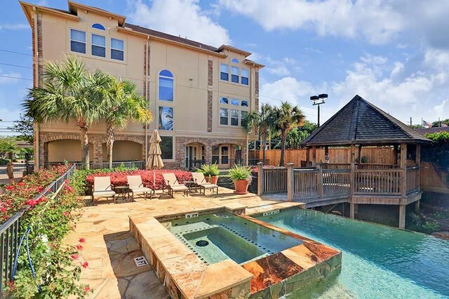 5768 Sugar Hill Dr, Houston, TX 77057 - view of swimming pool with a patio area, a gazebo, fence, and a pool with connected hot tub