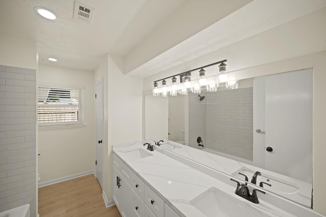 13510 Cedar Point Dr, Cypress, TX 77429 - bathroom with wood finished floors, a sink, walk in shower, toilet, and visible vents