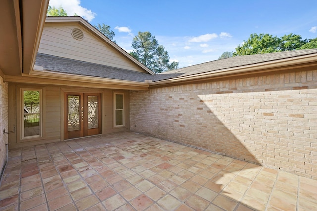 13510 Cedar Point Dr, Cypress, TX 77429 - view of exterior entry featuring a patio area, french doors, brick siding, and roof with shingles