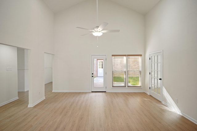13510 Cedar Point Dr, Cypress, TX 77429 - unfurnished living room with light wood-style flooring, baseboards, high vaulted ceiling, and a ceiling fan