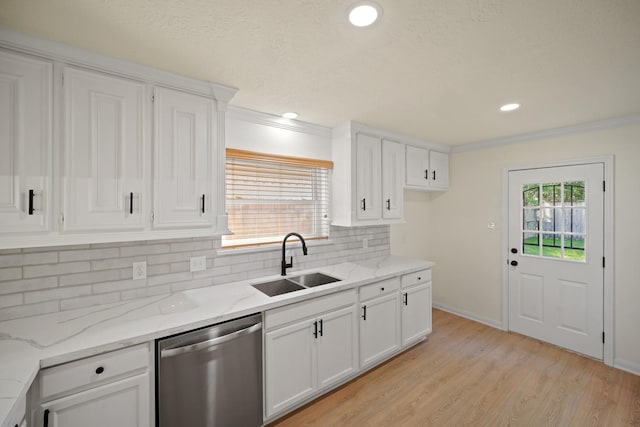 13510 Cedar Point Dr, Cypress, TX 77429 - kitchen featuring light wood finished floors, a sink, tasteful backsplash, white cabinetry, and dishwasher