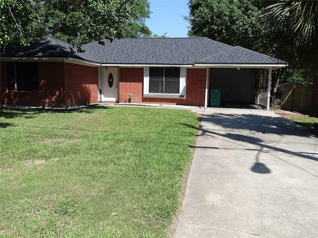 117 N Forest Dr, Willis, TX 77378 - ranch-style house featuring a carport, a front yard, brick siding, a shingled roof, and concrete driveway
