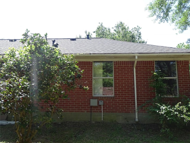 117 N Forest Dr, Willis, TX 77378 - view of property exterior featuring brick siding and roof with shingles