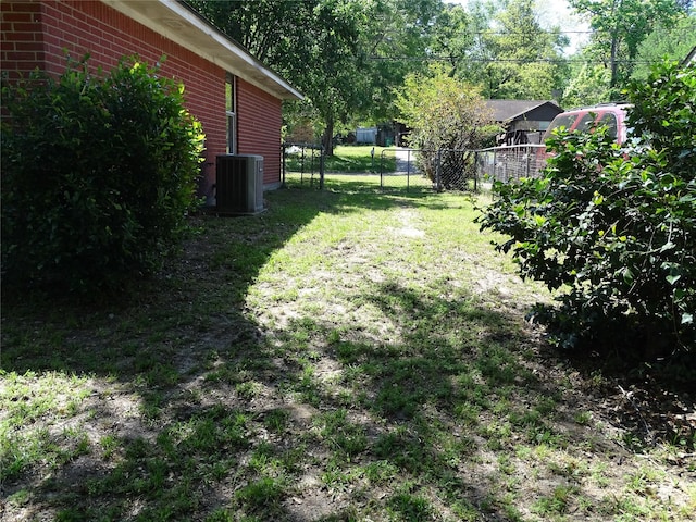 117 N Forest Dr, Willis, TX 77378 - view of yard with central air condition unit and fence