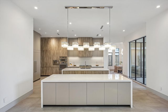 310 E Cowan Dr, Houston, TX 77007 - kitchen with a large island with sink, light countertops, modern cabinets, and recessed lighting