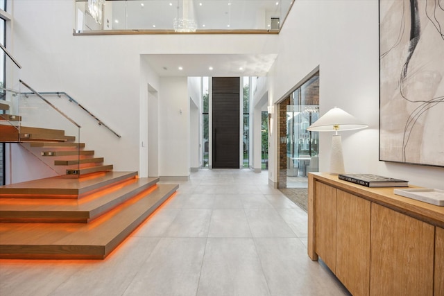 310 E Cowan Dr, Houston, TX 77007 - entryway featuring a high ceiling, light tile patterned flooring, and stairs