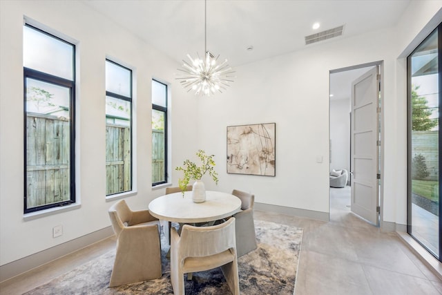 310 E Cowan Dr, Houston, TX 77007 - dining space featuring a chandelier, visible vents, baseboards, and a healthy amount of sunlight