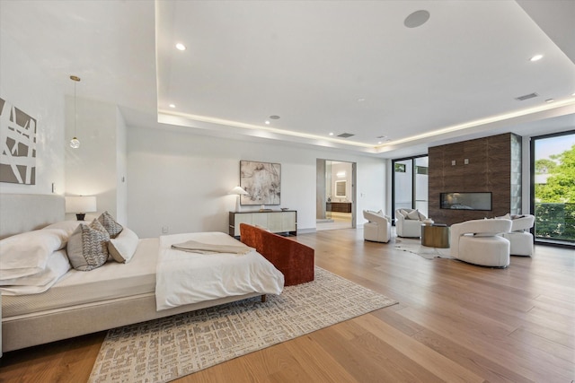 310 E Cowan Dr, Houston, TX 77007 - bedroom with visible vents, a tray ceiling, recessed lighting, and wood finished floors