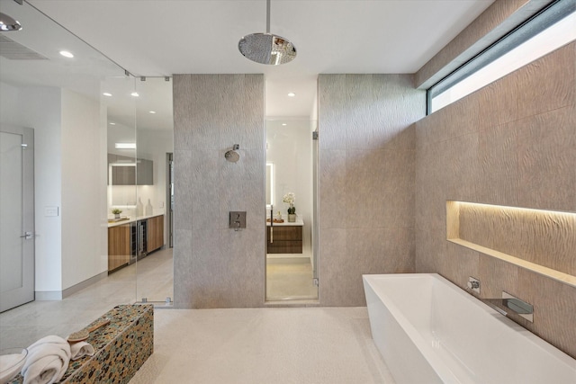 310 E Cowan Dr, Houston, TX 77007 - full bathroom featuring tile patterned floors, tiled shower, vanity, and a soaking tub