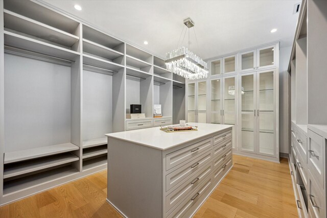 310 E Cowan Dr, Houston, TX 77007 - spacious closet with an inviting chandelier, light wood-style floors, and visible vents