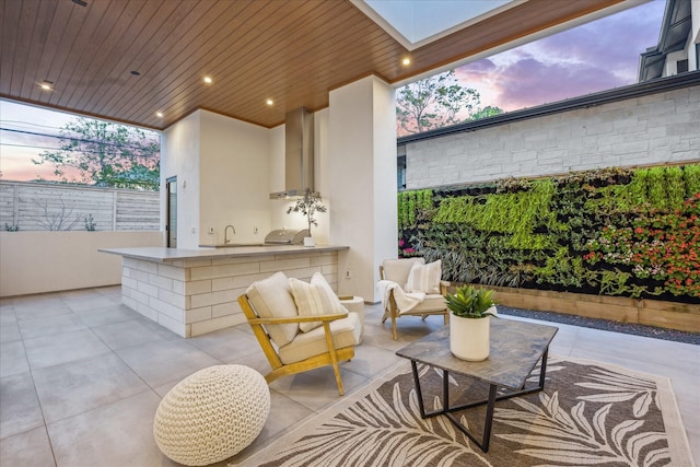 310 E Cowan Dr, Houston, TX 77007 - patio terrace at dusk featuring a grill, an outdoor kitchen, an outdoor hangout area, and a sink
