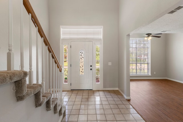 10223 Dude Rd, Houston, TX 77064 - foyer featuring visible vents, stairway, a towering ceiling, and a ceiling fan