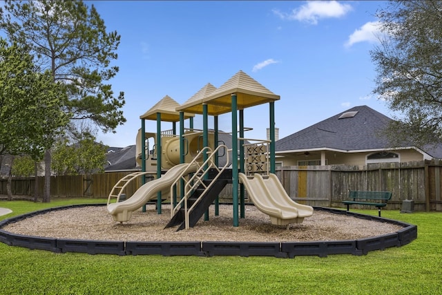 community playground featuring fence and a lawn