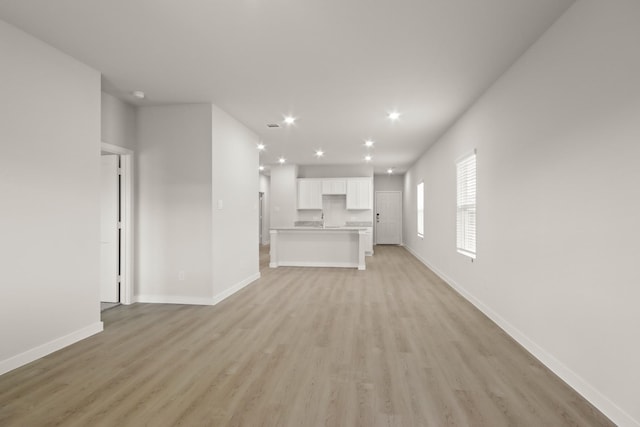 17836 Lionheart Rd, Conroe, TX 77306 - unfurnished living room with light wood-type flooring, baseboards, and recessed lighting