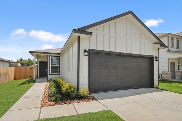 17836 Lionheart Rd, Conroe, TX 77306 - view of front of property with board and batten siding, an attached garage, and concrete driveway