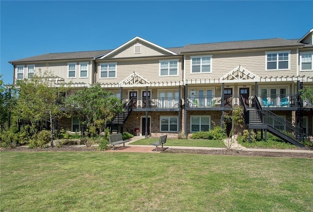 view of front of house with a front lawn and stairs