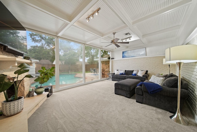 sunroom / solarium with beamed ceiling, rail lighting, and coffered ceiling