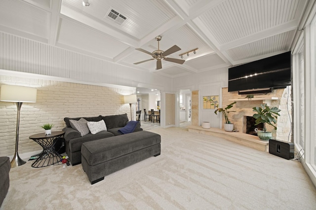 carpeted living room with a ceiling fan, brick wall, visible vents, beamed ceiling, and coffered ceiling