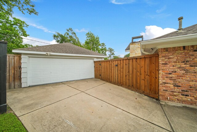 detached garage featuring fence