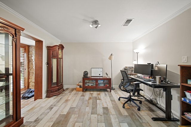 office featuring crown molding, baseboards, wood finished floors, and visible vents
