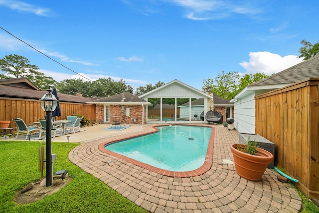 view of swimming pool featuring a fenced backyard, a fenced in pool, an outdoor structure, and a patio area