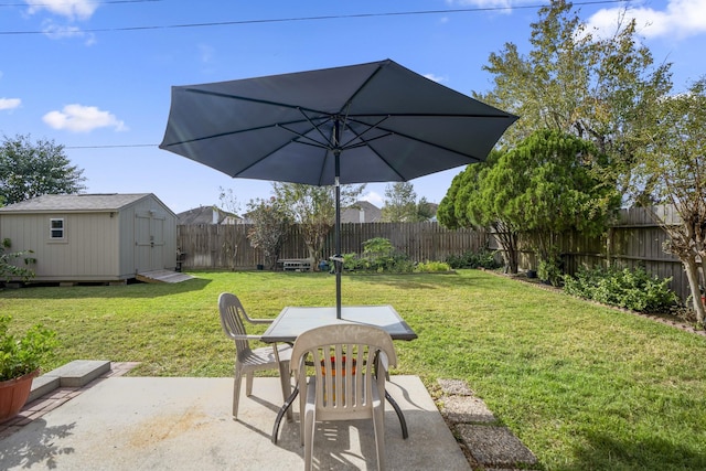 view of yard featuring a storage shed, a patio area, a fenced backyard, outdoor dining space, and an outdoor structure