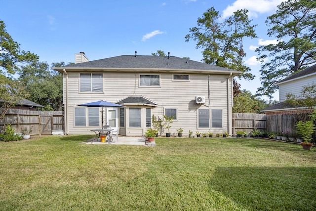 rear view of property featuring a patio area, a fenced backyard, and a yard