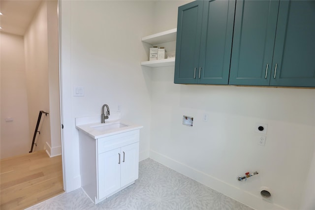 603 Neyland St, Houston, TX 77022 - laundry area featuring hookup for a gas dryer, light flooring, electric dryer hookup, cabinet space, and baseboards