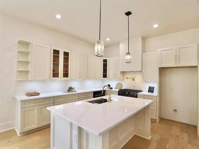 603 Neyland St, Houston, TX 77022 - kitchen featuring a sink, black gas range oven, tasteful backsplash, light wood-type flooring, and recessed lighting