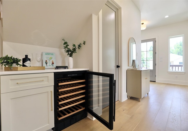 603 Neyland St, Houston, TX 77022 - indoor dry bar with beverage cooler, light wood-style floors, recessed lighting, and baseboards