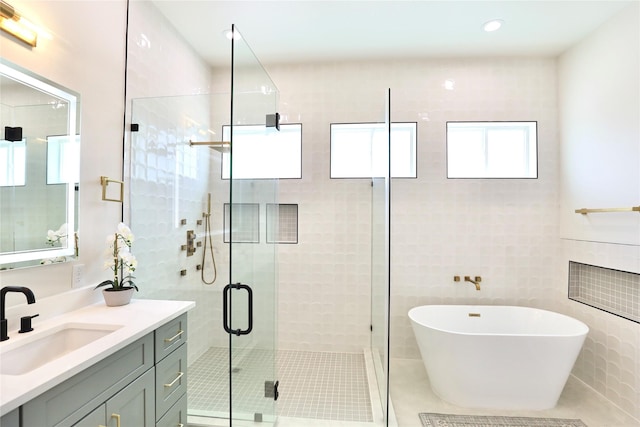 603 Neyland St, Houston, TX 77022 - full bath featuring vanity, a freestanding tub, a shower stall, tile patterned flooring, and recessed lighting