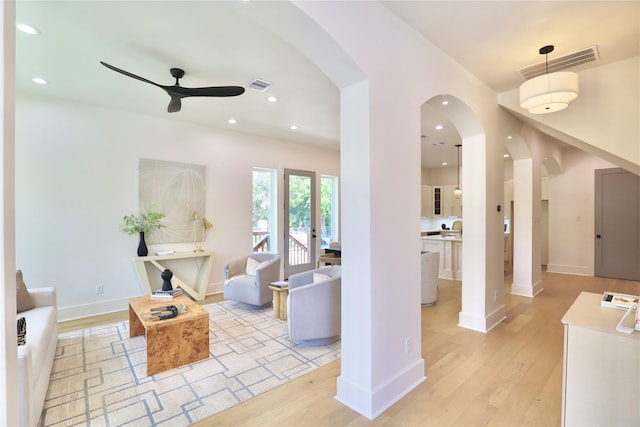 603 Neyland St, Houston, TX 77022 - living area with ceiling fan, light wood-style flooring, arched walkways, recessed lighting, and baseboards