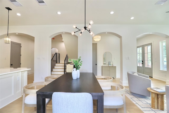 603 Neyland St, Houston, TX 77022 - dining room with stairway, recessed lighting, arched walkways, light wood-style floors, and french doors